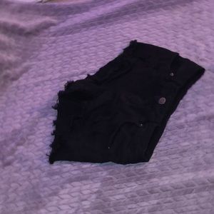 black jean shorts with rips in them